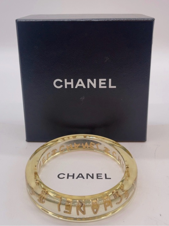 CHANEL Jewelry - CHANEL LUCITE & Gold Letter Clear Acrylic Bangle
